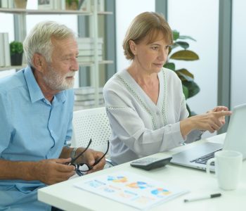 senior couple reviewing annuity info on computer