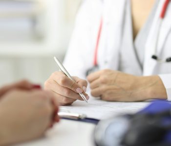 doctor sitting at table with patient