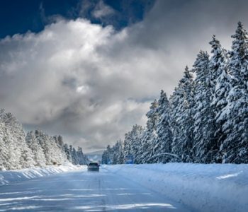 car traveling snow-covered road in winter