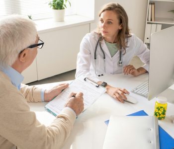 female doctor discussing preventive services with senior man