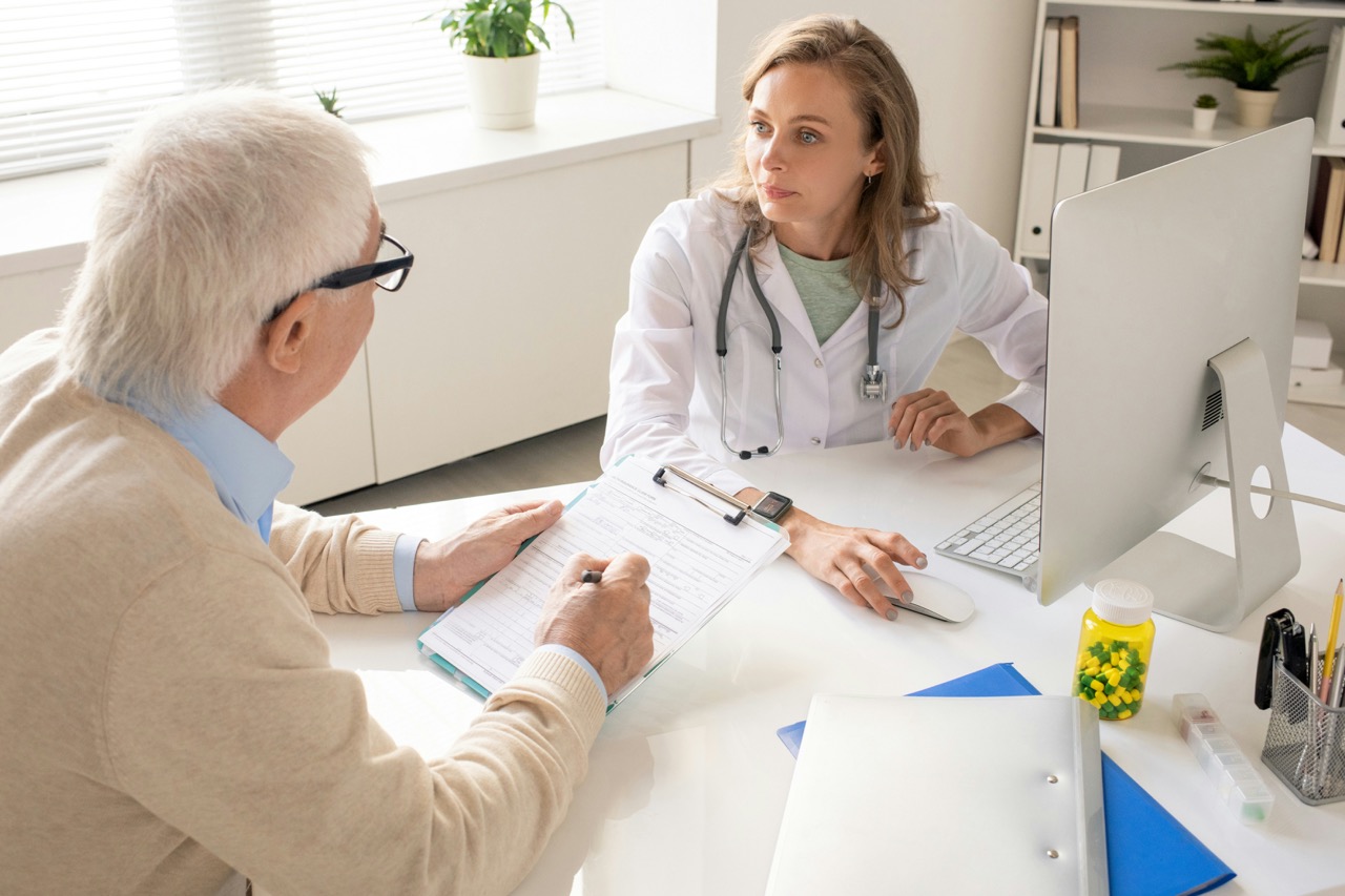 female doctor discussing preventive services with senior man