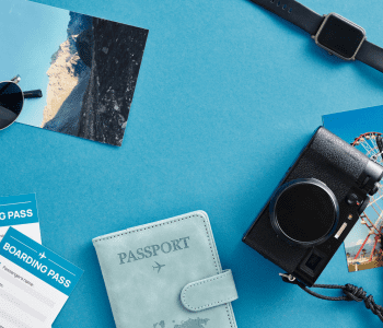 passport and other travel items on blue surface