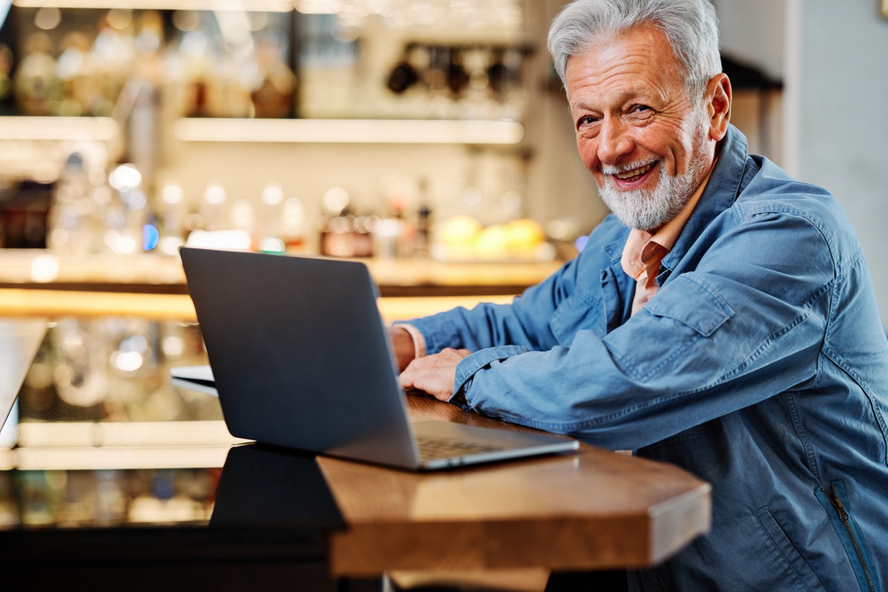 senior man using laptop to find Medicare education